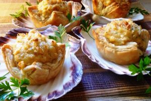 Crab Pastry Cups on seashell plates with a parsley garnish