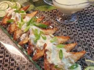 Greek Crab Rangoon on a Clear Plate with Cucumber Garnish