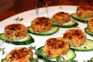 Mini Crab Cakes on Cucumber Slices on a white plate