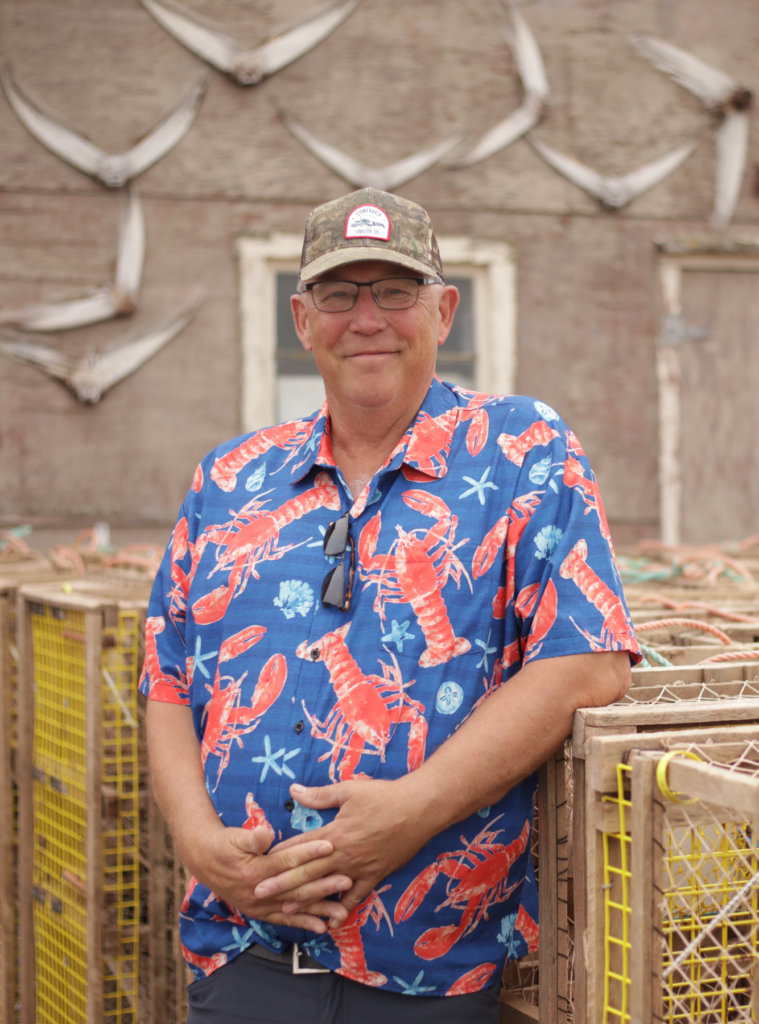 Captain John W. MacDonald standing next to lobster traps.